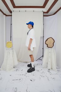 Baptismal baseball cap, side drape shirt, chunky magnetic string of stones, 2D round silhouette shorts