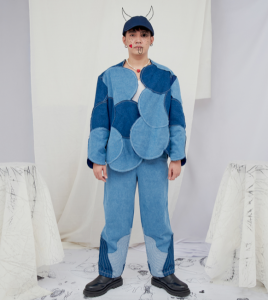 The denim bubble jacket, baptismal baseball cap, ring of trees jeans, skinny magnetic string of stones necklace